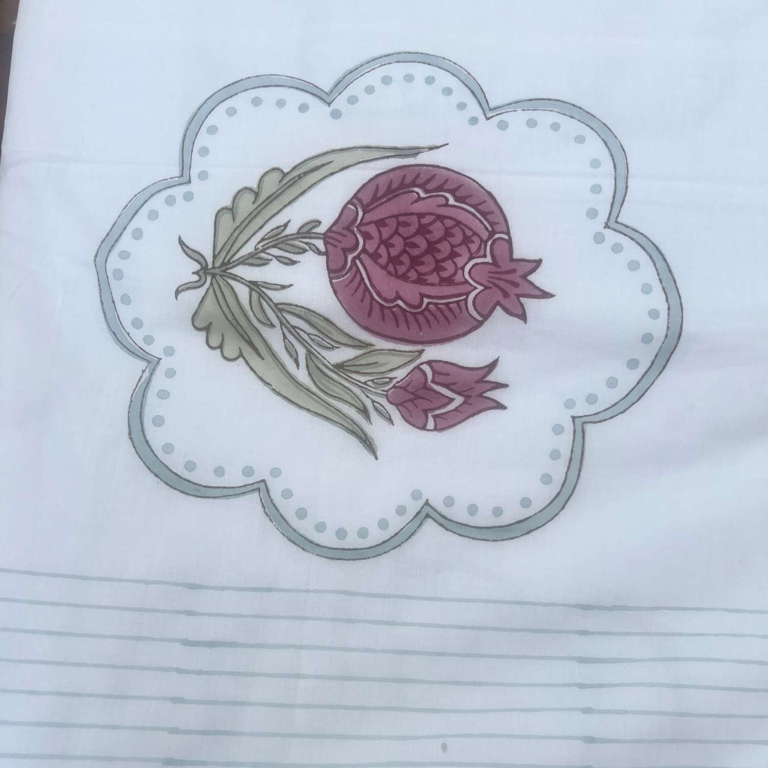 Decorative floral design with a pomegranate on lined paper