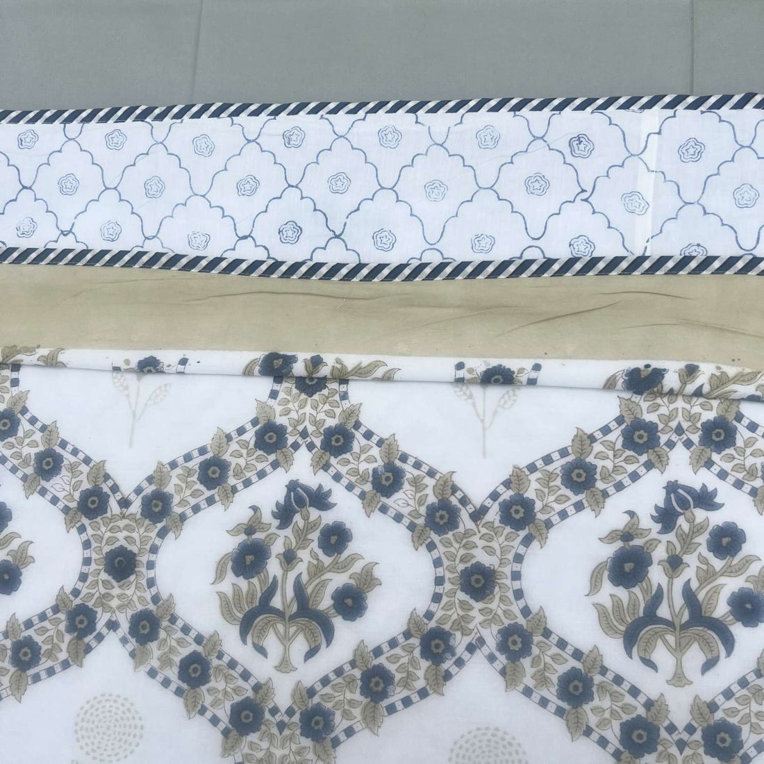 Floral patterned quilt on a bed with a neutral background