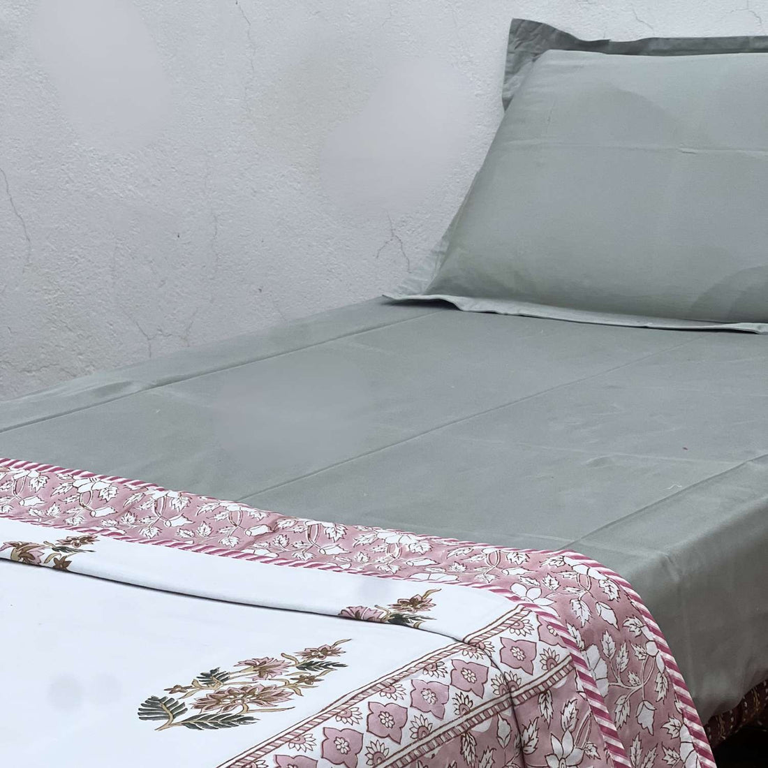 Floral patterned fabric with pink and white flowers on a striped background