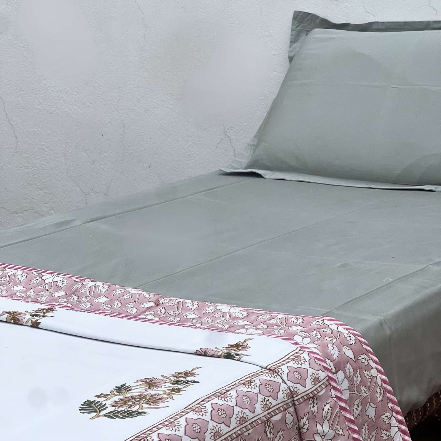 Floral patterned fabric with pink and white flowers on a striped background
