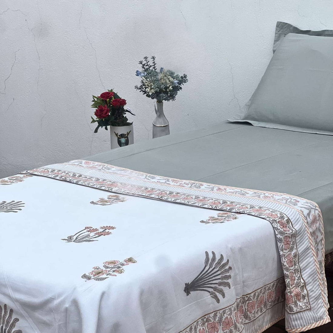 Embroidered floral design on a white fabric background